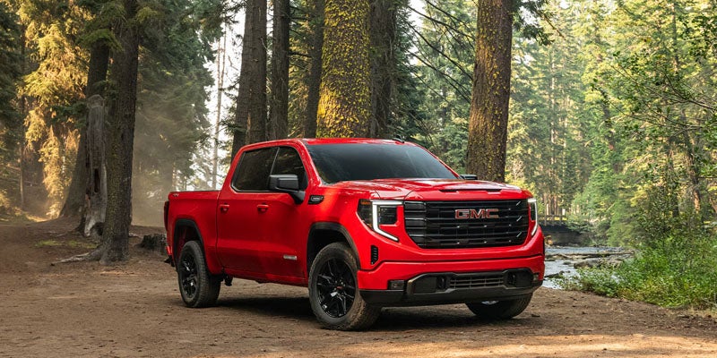 Red GMC Sierra Forest Trail
